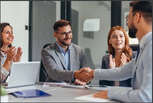 Business team shaking hands during a portfolio meeting